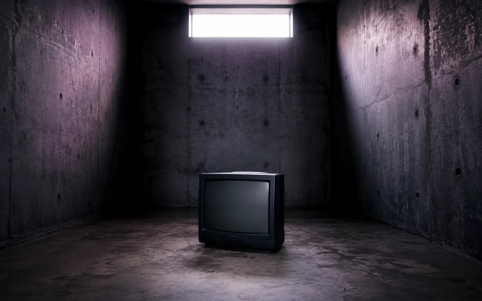An old television in a dimly lit concrete room, illustrative image for the article